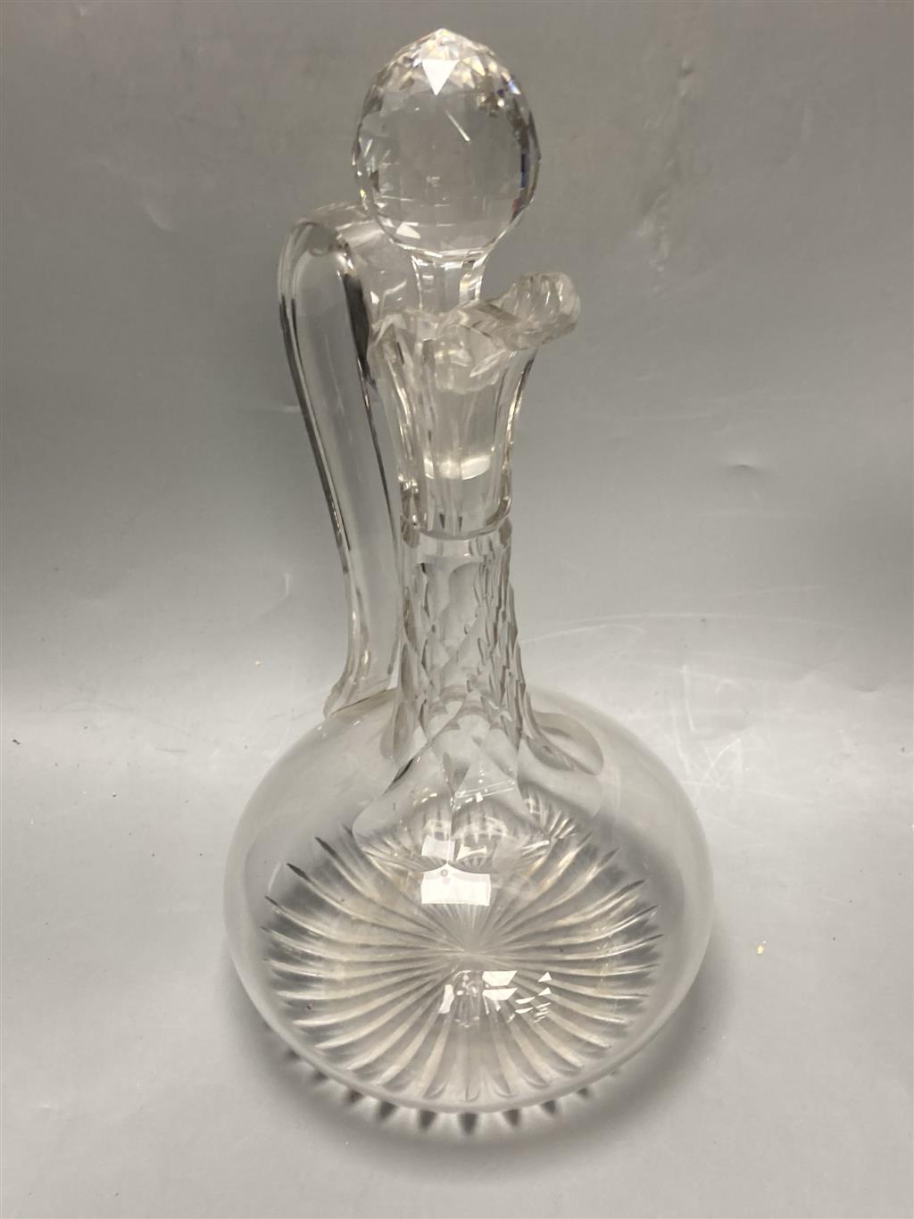 A pair of early 19th century cut glass decanters, height 24cm and an Edwardian claret jug, height 30cm (one decanter a.f.)